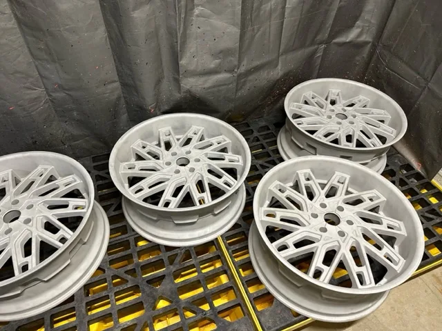 Set of wheels media-blasted to bare metal, ready to coat